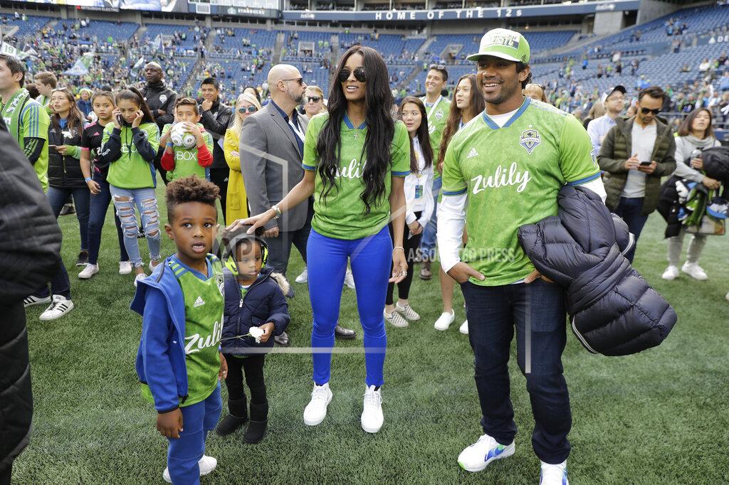 Ted S. Warren Seattle Sounders minority owners Russell Wilson, right, the quarterback for the NFL football Seattle Seahawks, and his wife, pop singer Ciara, second from right, stand with their daughter, Sienna, second from left, and Ciara's son Future, left, after an MLS soccer match against Minnesota United, Sunday, Oct. 6, 2019, in Seattle. The Sounders won 1-0. (AP Photo/Ted S. Warren)