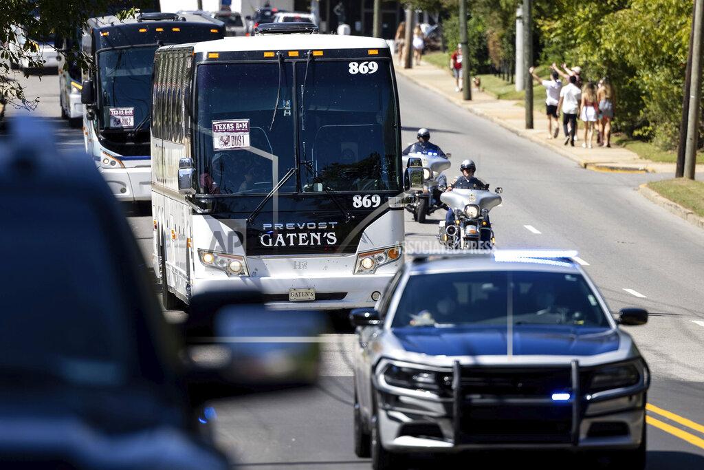 Vasha Hunt Texas A&M's caravan of buses arrives with a police escort for the team's NCAA college football game against Alabama on Saturday, Oct. 3, 2020, in Tuscaloosa, Ala. Only 20,000 fans were allowed to attend, meaning many did not travel to the city, while others sought social opportunities at restaurants and bars. (AP Photo/Vasha Hunt)