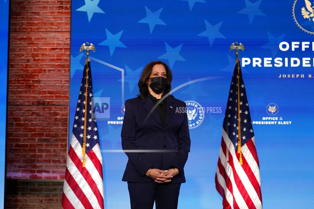 Vice President-elect Kamala Harris listens as President-elect Joe Biden speaks during an event at The Queen theater, Friday, Jan. 15, 2021, in Wilmington, Del. (AP Photo/Matt Slocum)