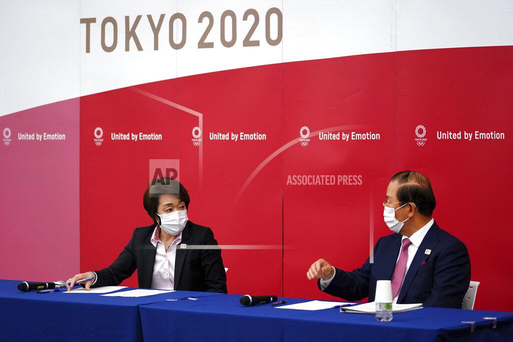 Seiko Hashimoto, left, president of the Tokyo 2020 Organizing Committee of the Olympic and Paralympic Games (Tokyo 2020), left, speaks during a news conference with Toshiro Muto, CEO of Tokyo 2020, attend a news conference Thursday, March 11, 2021, following the International Olympic Committee (IOC) general meeting. (AP Photo/Eugene Hoshiko, Pool)