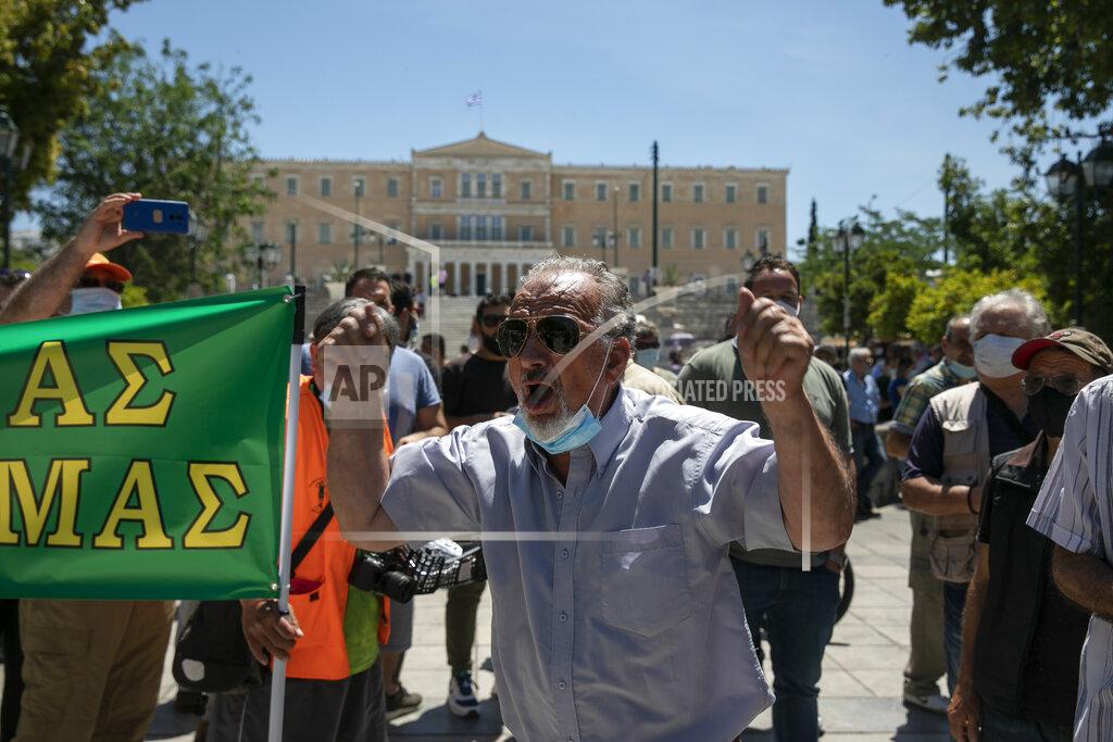 Yorgos Karahalis A dog owner shouts slogans during a rally against a proposed law by the government related to household pets, at Syntagma square, in Athens, Sunday, May 23, 2021. Several hundred dog owners, most of them also hunters, and their pets, protested outside the Greek Parliament Sunday against a new law, still at the consultation stage, that mandates sterilization of household pets. (AP Photo/Yorgos Karahalis)