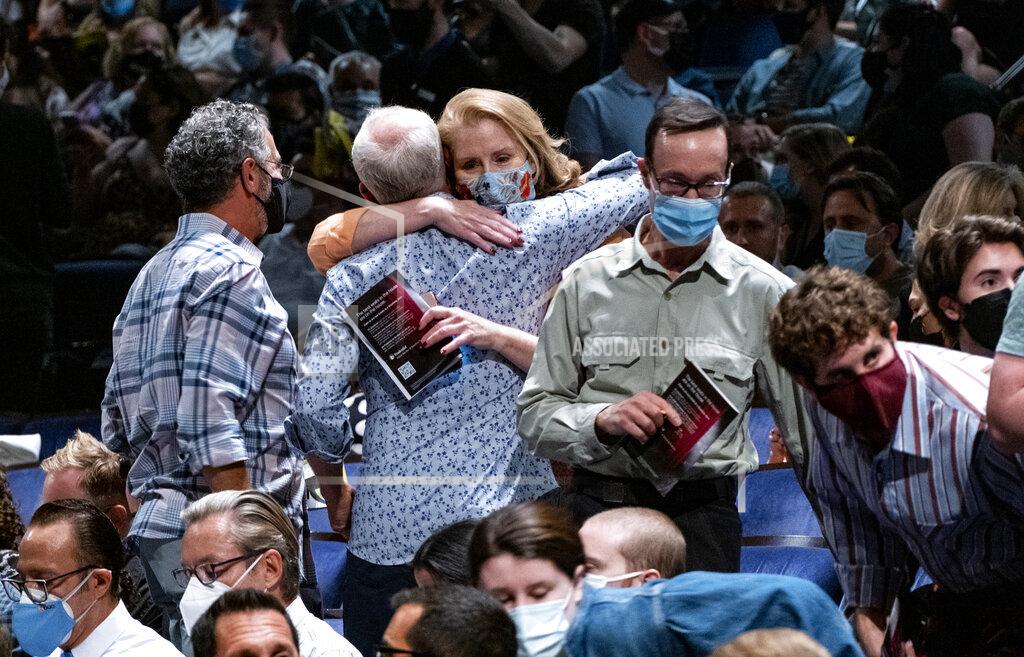 Craig Ruttle People embrace at the at the Gershwin Theatre before the opening of "Wicked" Tuesday, Sept. 14, 2021, in New York. The show opened today after being closed due to Covid-19 concerns in early 2020. (AP Photo/Craig Ruttle)