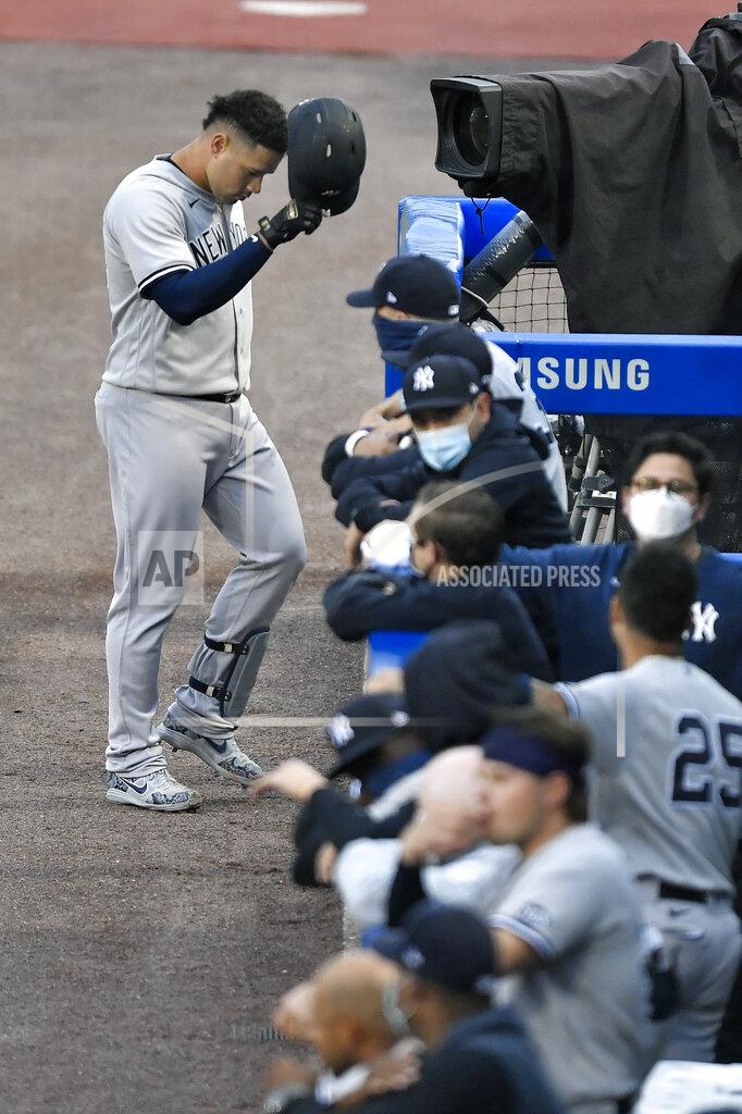 Adrian Kraus New York Yankees' Gary Sanchez, top, walks back to the dugout after grounding out to Toronto Blue Jays third baseman Joe Panik during the second inning of a baseball game in Buffalo, N.Y., Tuesday, Sept. 8, 2020. (AP Photo/Adrian Kraus)
