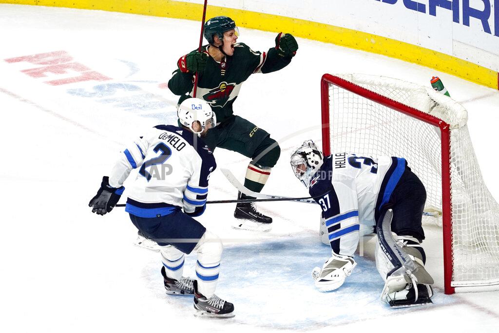 Jim Mone Minnesota Wild's Joel Eriksson Ek, top, celebrates his overtime goal against Winnipeg Jets goalie Connor Hellebuyck, right, in an NHL hockey game Tuesday, Oct. 19, 2021, in St. Paul, Minn. The Wild won 6-5. (AP Photo/Jim Mone)