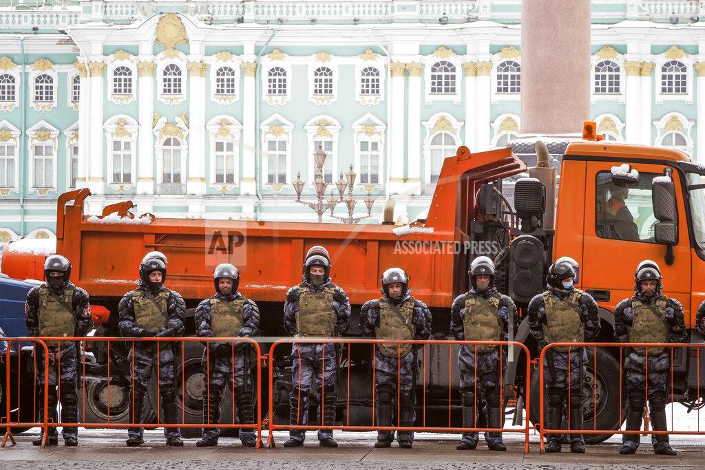 Russian Rosguardia (National Guard) soldiers stand blocking enter to the Palace Square a day before Sunday's protest in St. Petersburg, Russia, Saturday, Jan. 30, 2021. As part of a multipronged effort by the authorities to discourage Russians from attending Sunday's demonstrations, the Prosecutor General's office ordered the state communications watchdog, Roskomnadzor, to block the calls for joining the protests on the internet. The Prosecutor General's office and the Interior Ministry also issued stern warnings to the public not to join the protests, saying participants could face criminal charges of taking part in mass riots if the rallies turn violent. (AP Photo/Dmitri Lovetsky)