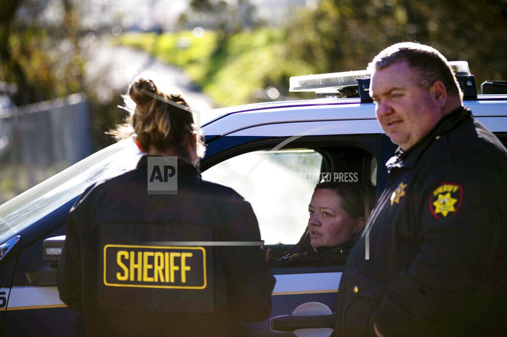 Aaron Kehoe San Mateo Sheriffs protect the police line at the crime scene at Mountain Mushroom Farm, Tuesday, Jan. 24, 2023, after a gunman killed several people at two agricultural businesses in Half Moon Bay, Calif. Officers arrested a suspect in Monday’s shootings, 67-year-old Chunli Zhao, after they found him in his car in the parking lot of a sheriff’s substation, San Mateo County Sheriff Christina Corpus said. (AP Photo/Aaron Kehoe)