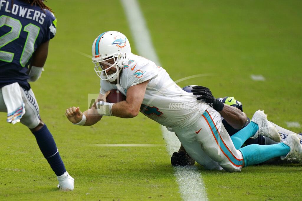 Wilfredo Lee Miami Dolphins quarterback Ryan Fitzpatrick (14) scores a touchdown, during the second half of an NFL football game against the Seattle Seahawks, Sunday, Oct. 4, 2020 in Miami Gardens, Fla. (AP Photo/Wilfredo Lee)