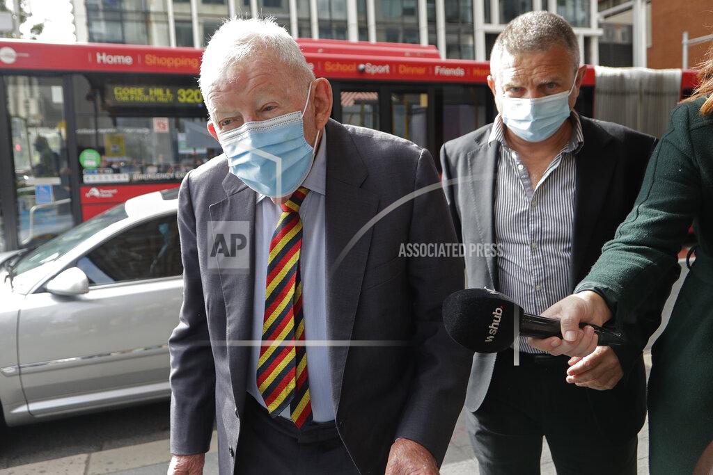 Rick Rycroft New Zealand businessmen Ron Brierley, left, arrives at the Local Downing Centre Court in Sydney, Thursday, Oct. 14, 2021, to be sentenced for possessing child sex abuse images. Brierley, one of New Zealand’s most well-known businessmen, was sentenced to 14 months in prison for possessing child sex abuse images. (AP Photo/Rick Rycroft)