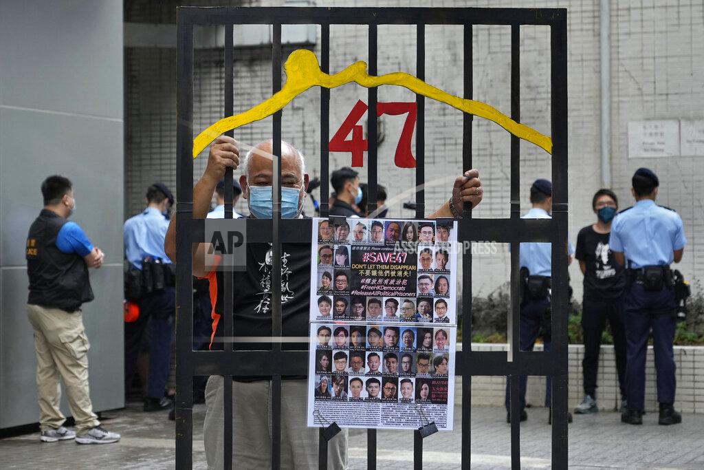 Vincent Yu A protester stands behind a mock prison while police officers do search to other protesters during a protest against an election committee that will vote for the city's leader in Hong Kong Sunday, Sept. 19, 2021. Hong Kong's polls for an election committee that will vote for the city's leader kicked off Sunday amid heavy police presence, with chief executive Carrie Lam saying that it is "very meaningful" as it is the first election to take place following electoral reforms. (AP Photo/Vincent Yu)