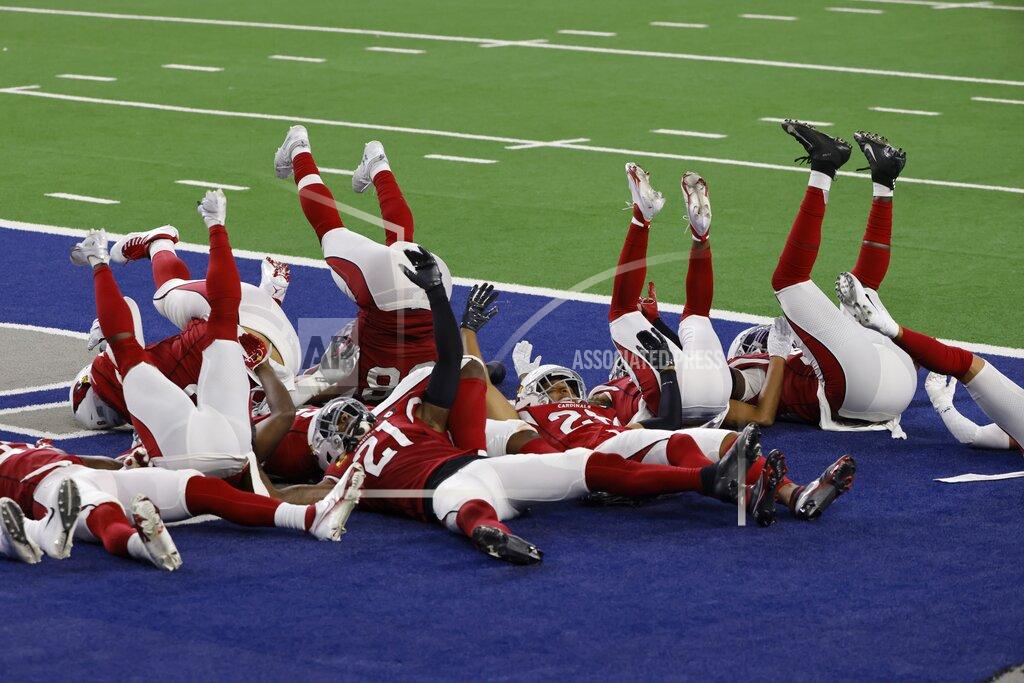 Ron Jenkins Members of the Arizona Cardinals defense act out a bowling pin strike dramatization after being hit by a ball rolled by Byron Murphy Jr. who intercepted a Dallas Cowboys quarterback Andy Dalton pass in the second half of an NFL football game in Arlington, Texas, Monday, Oct. 19, 2020. (AP Photo/Ron Jenkins)