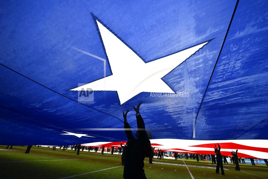 Denis Poroy United States Navy sailors hold up a giant U.S. flag before the Holiday Bowl NCAA college football game between Utah and Northwestern, Monday, Dec. 31, 2018, in San Diego. (AP Photo/Denis Poroy)