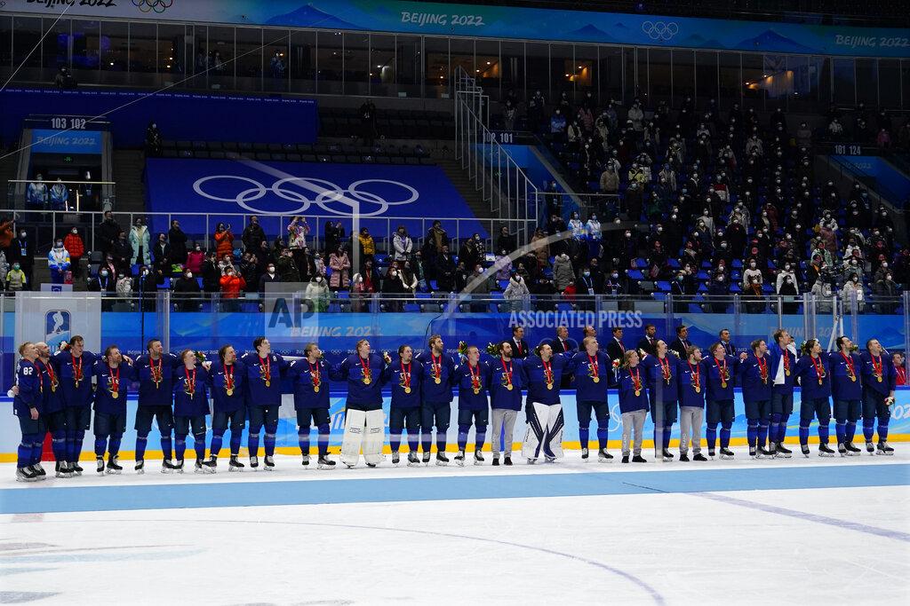 Matt Slocum Finland players watch the raising of their flag during the medal ceremony after defeating Russian Olympic Committee in the men's gold medal hockey game at the 2022 Winter Olympics, Sunday, Feb. 20, 2022, in Beijing. (AP Photo/Matt Slocum)