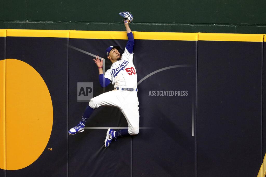 Curtis Compton Los Angeles Dodgers right fielder Mookie Betts makes a catch and robs a home run from Atlanta Braves' Freddie Freeman during the fifth inning in Game 7 of a baseball National League Championship Series, Sunday, Oct. 18, 2020, in Arlington, Texas. (Curtis Compton/Atlanta Journal-Constitution via AP)