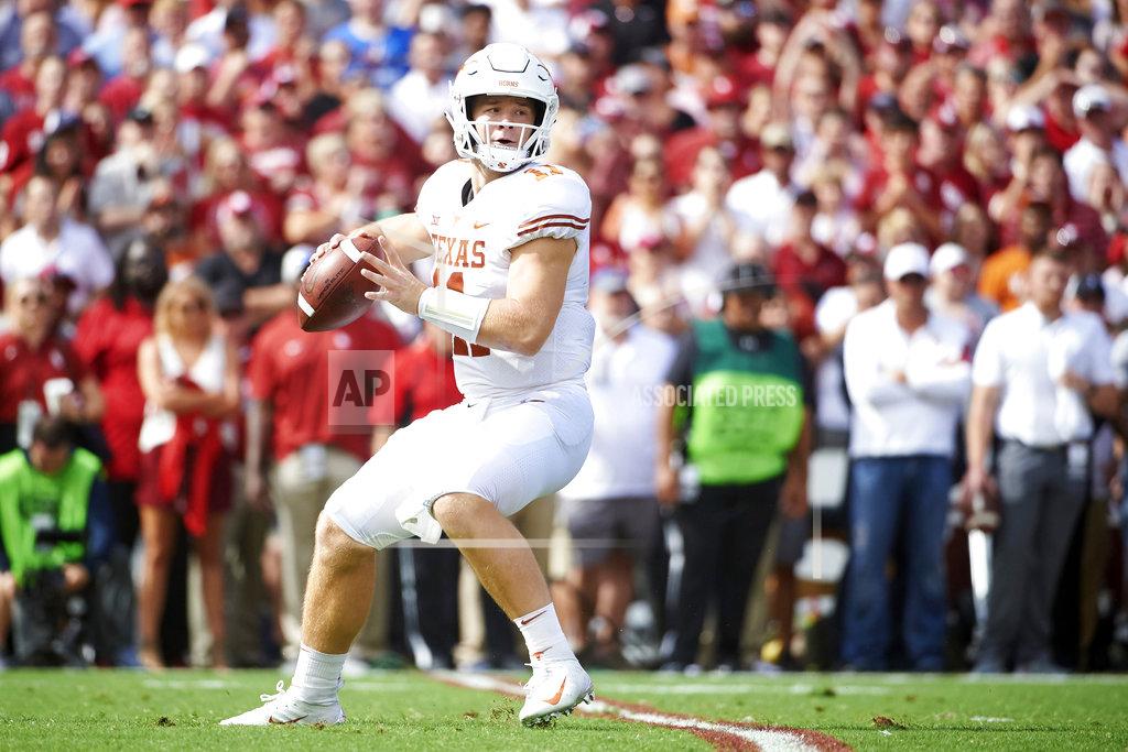 Cooper Neill Texas quarterback Sam Ehlinger (11) drops back to pass against Oklahoma during the first half of an NCAA college football game at the Cotton Bowl, Saturday, Oct. 6, 2018, in Dallas. (AP Photo/Cooper Neill)