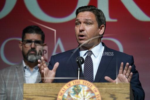FILE - In this Tuesday, Sept. 14, 2021, file photo, Florida Gov. Ron DeSantis speaks at the Doral Academy Preparatory School in Doral, Fla. Florida filed suit against President Joe Biden's administration Tuesday, Sept. 28, 2021, claiming his immigration policy is illegal, and DeSantis signed an order barring state agencies from assisting with the relocation of undocumented immigrants arriving in the state. (AP Photo/Wilfredo Lee. File)