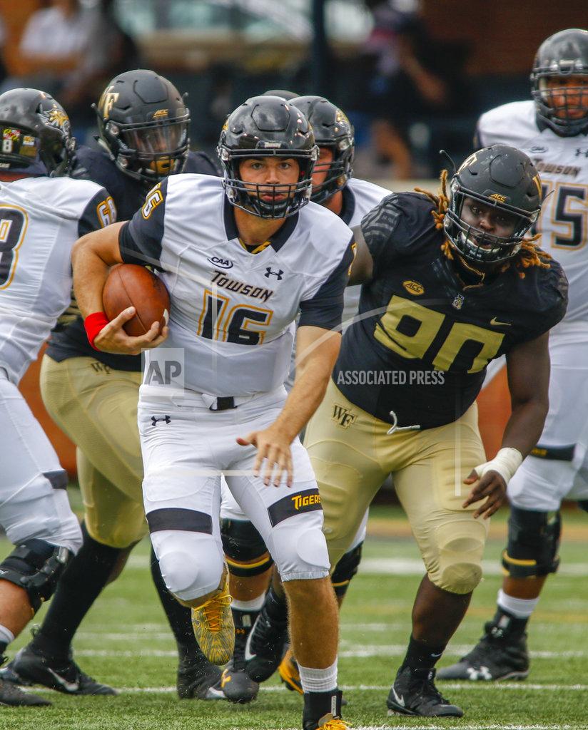 Nell Redmond Towson quarterback Ryan Stover rushes for a first down ahead of Wake Forest defensive lineman Sulaiman Kamara (90) in the second half of an NCAA college football game in Winston-Salem, N.C., Saturday, Sept. 8, 2018. (AP Photo/Nell Redmond)
