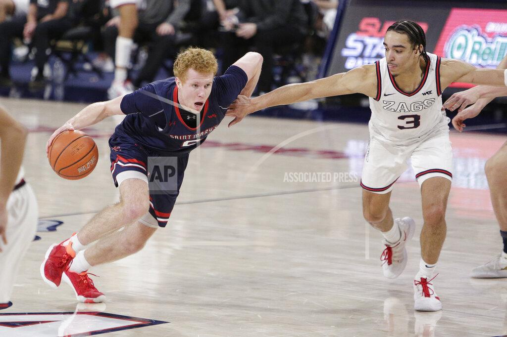 Young Kwak Saint Mary's guard Jabe Mullins, left, drives while pressured by Gonzaga guard Andrew Nembhard during the second half of an NCAA college basketball game in Spokane, Wash., Thursday, Feb. 18, 2021. (AP Photo/Young Kwak)