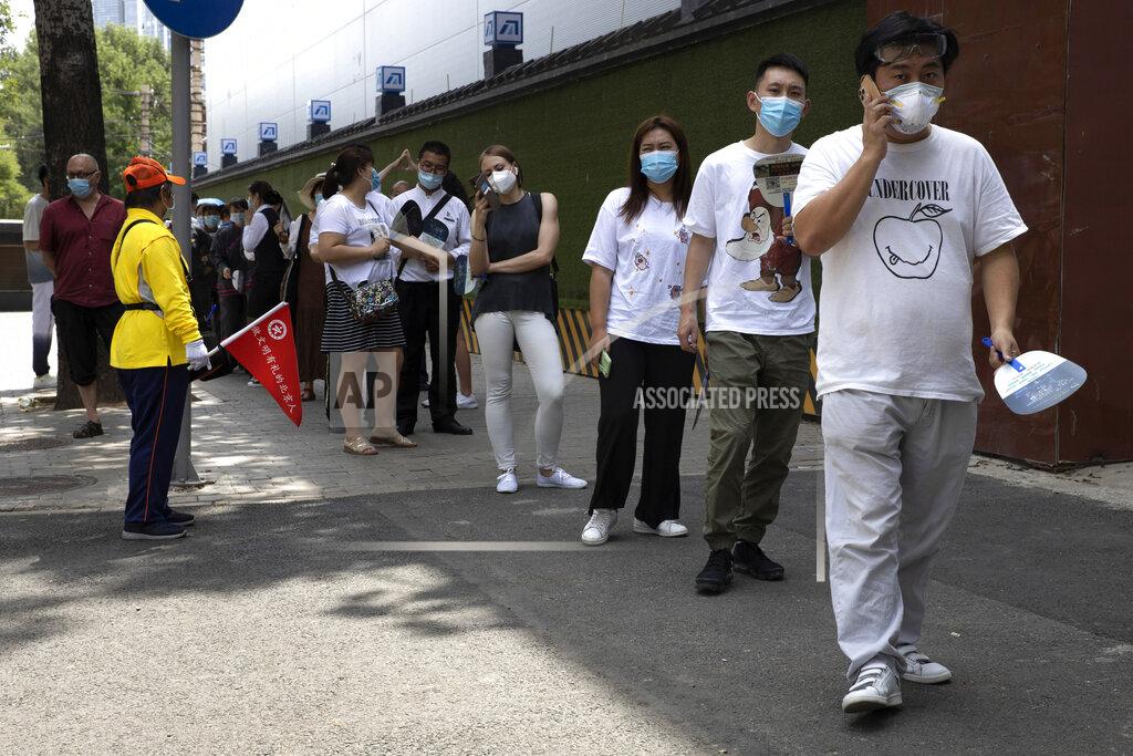 Ng Han Guan Residents wearing masks to curb the spread of the coronavirus line up for COVID-19 test outside the Worker's Stadium in Beijing on Tuesday, June 30, 2020. Test sites have sprung up through the Chinese capital as test have become a daily normal after the latest outbreak of the coronavirus, (AP Photo/Ng Han Guan)