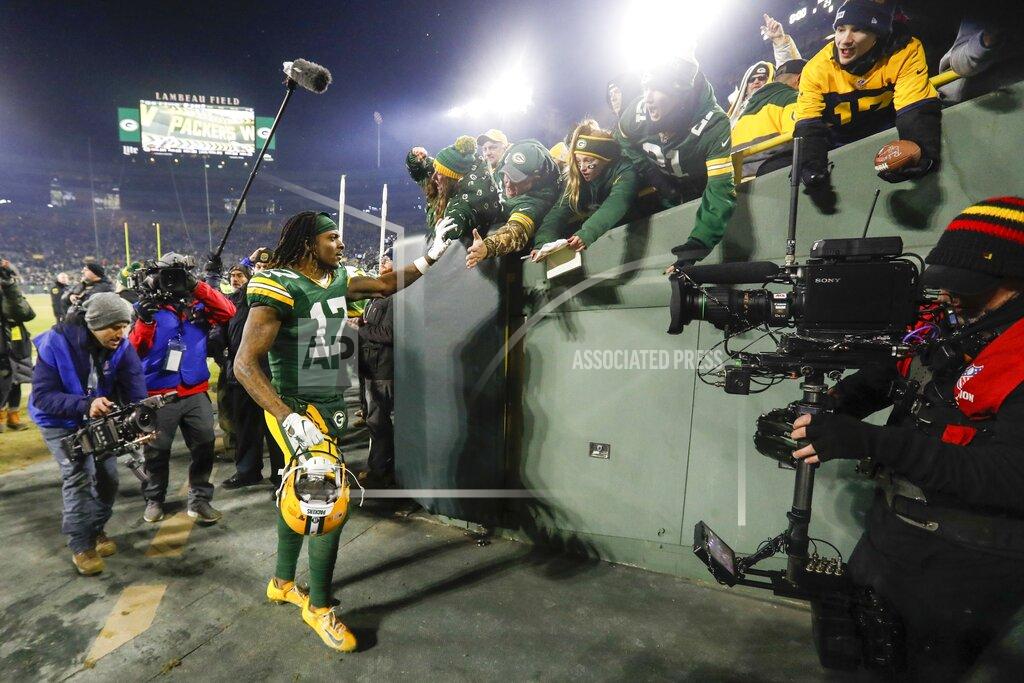Mike Roemer Green Bay Packers' Davante Adams celebrates with fans after an NFL divisional playoff football game against the Seattle Seahawks Sunday, Jan. 12, 2020, in Green Bay, Wis. The Packers won 28-23 to advance to the NFC Championship. (AP Photo/Mike Roemer)
