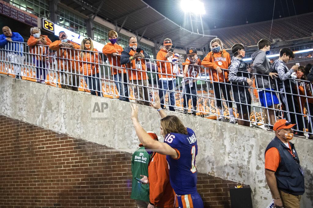 Ken Ruinard Clemson quarterback Trevor Lawrence (16) waves to fans as he leaves the team's home field for the last time, after the team's win over Pittsburgh in an NCAA college football game Saturday, Nov 28, 2020, in Clemson, S.C. (Ken Ruinard/The Independent-Mail via AP, Pool)