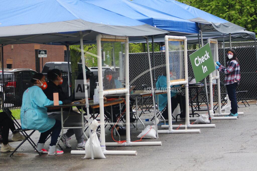 Noreen Nasir In this May 14, 2020 photo, a new testing site opened in the Little Village neighborhood of Chicago after initial reports that testing was lacking in the area. Chicago’s Little Village neighborhood is known as the heart of Mexican culture in the city. It’s also located in the zip code area with one of the highest rates of positive coronavirus cases in the city. Across the country, states reporting racial data indicate similar trends, with overwhelmingly high rates of infection within the Latino population. (AP Photo/Noreen Nasir)