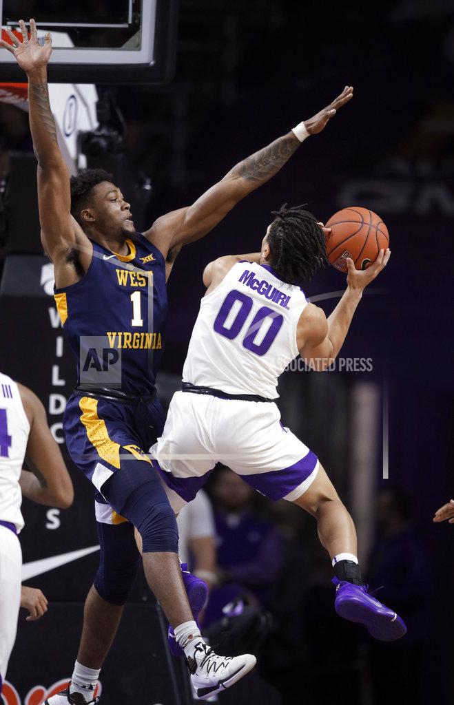 Orlin Wagner Kansas State guard Mike McGuirl (00) is defended by West Virginia forward Derek Culver (1) during the first half of an NCAA college basketball game in Manhattan, Kan., Wednesday, Jan. 9, 2019. (AP Photo/Orlin Wagner)