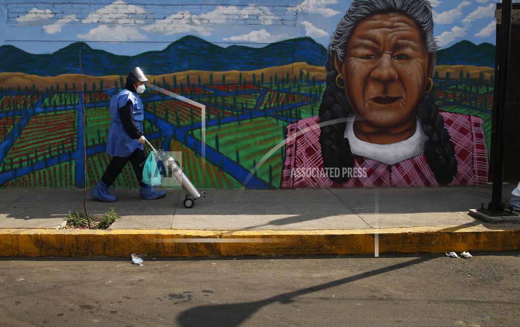 Marco Ugarte City worker Alexis Hernandez delivers a tank of oxygen to a COVID-19 patient, in the Iztapalapa borough of Mexico City, Friday, Jan. 15, 2021. The city offers free oxygen refills for COVID-19 patients. (AP Photo/Marco Ugarte)