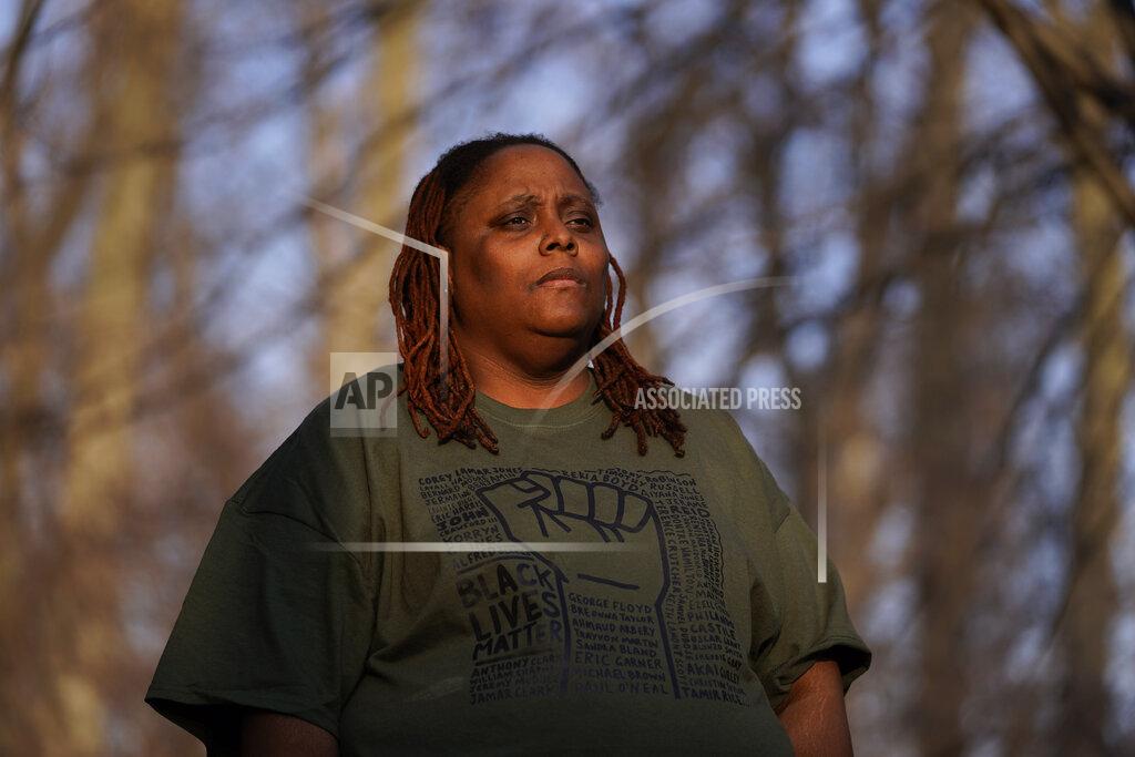 Paul Sancya Latoria Glenn-Carr poses for a photo in Westland, Mich.,Tuesday, March 9, 2021. Glenn-Carr and her wife of six years, Tyeisha, were diagnosed with coronavirus at a hospital emergency room near their home on Oct. 29. Despite Latoria's qualms, they were sent home. Tyeisha, 43, died in bed next to her wife three days later. One month later, COVID killed Glenn-Carr's mother, too. (AP Photo/Paul Sancya)