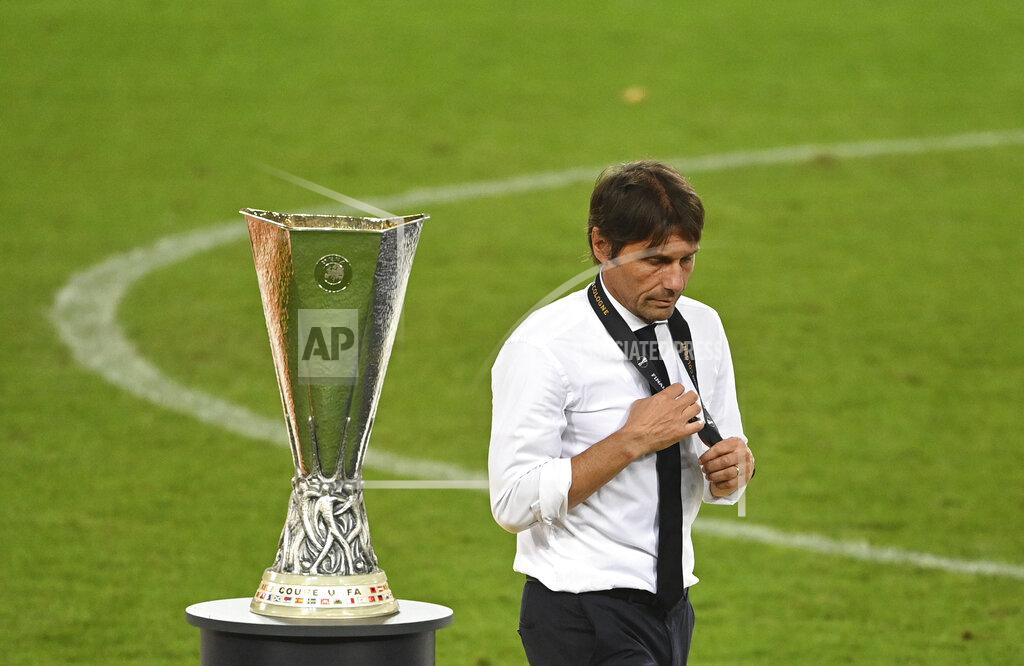Ina Fassbender FILE - In this Aug. 21, 2020 file photo, Inter Milan's head coach Antonio Conte walks past the trophy after the Europa League final soccer match between Sevilla and Inter Milan in Cologne, Germany. With the new Serie A season set to begin this weekend, the annual question arises: can anyone stop Juventus? (Ina Fassbender/Pool via AP)