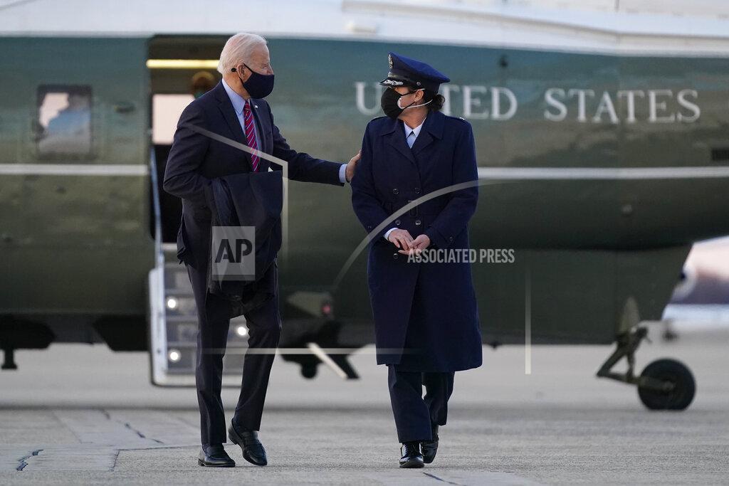 Patrick Semansky President Joe Biden speaks with a member of the U.S. Air Force after handing her a challenge coin as he walks to Air Force One at Andrews Air Force Base, Md., Friday, Feb. 5, 2021. Biden is spending the weekend at his home in Delaware. (AP Photo/Patrick Semansky)