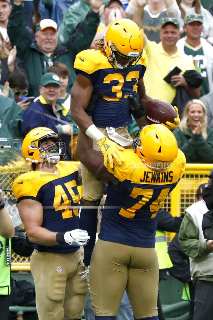 Matt Ludtke Green Bay Packers running back Aaron Jones (33) is congratulated by offensive guard Elgton Jenkins (74) and Danny Vitale (45) after scoring during the second half of an NFL football game against the Denver Broncos, Sunday, Sept. 22, 2019, in Green Bay, Wis. (AP Photo/Matt Ludtke)