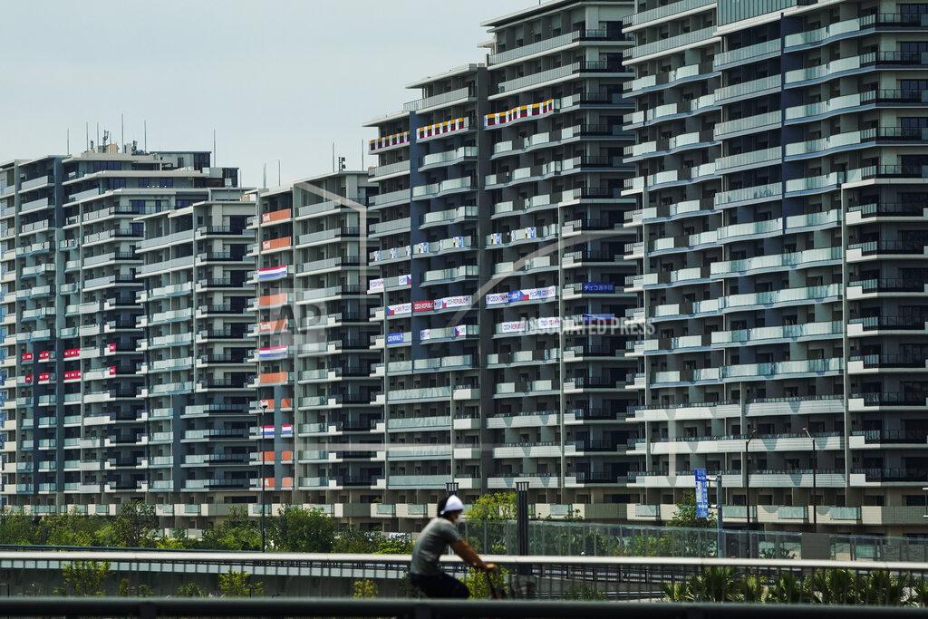 Jae C. Hong A man rides his bike near the athlete's village for the 2020 Summer Olympics and Paralympics, Thursday, July 15, 2021, in Tokyo. (AP Photo/Jae C. Hong)