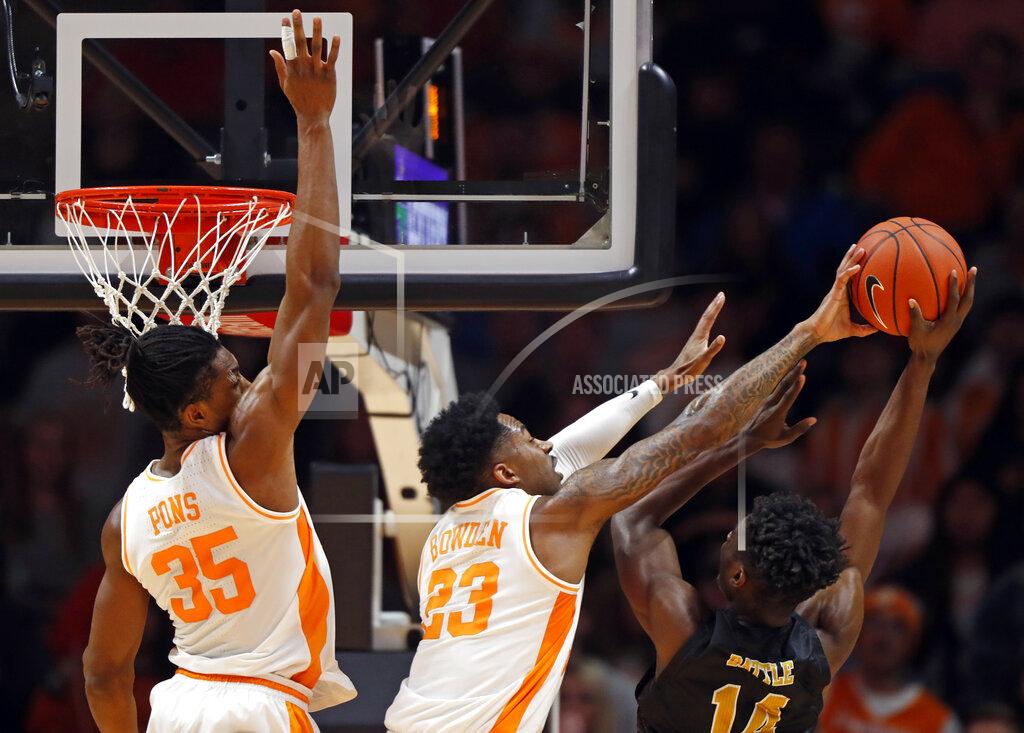 Wade Payne Alabama State forward Brandon Battle (14) has his shot blocked by Tennessee guard Jordan Bowden (23) during the first half of an NCAA college basketball game Wednesday, Nov. 20, 2019, in Knoxville, Tenn. Tennessee guard Yves Pons (35) is behind. (AP Photo/Wade Payne)