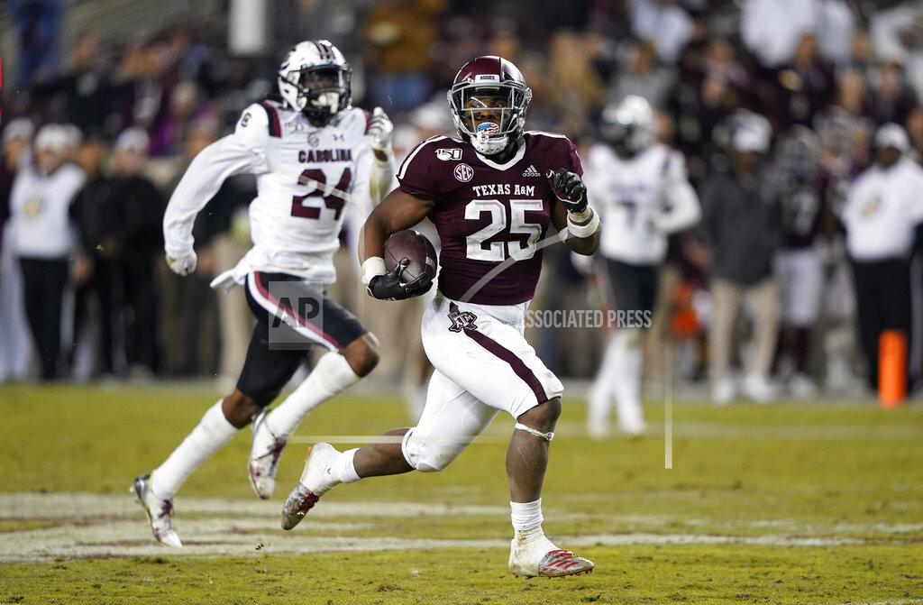 David J. Phillip Texas A&M running back Cordarrian Richardson (25) runs for a 75-yard touchdown as South Carolina defensive back Israel Mukuamu (24) chases him during the second half of an NCAA college football game Saturday, Nov. 16, 2019, in College Station, Texas. (AP Photo/David J. Phillip)