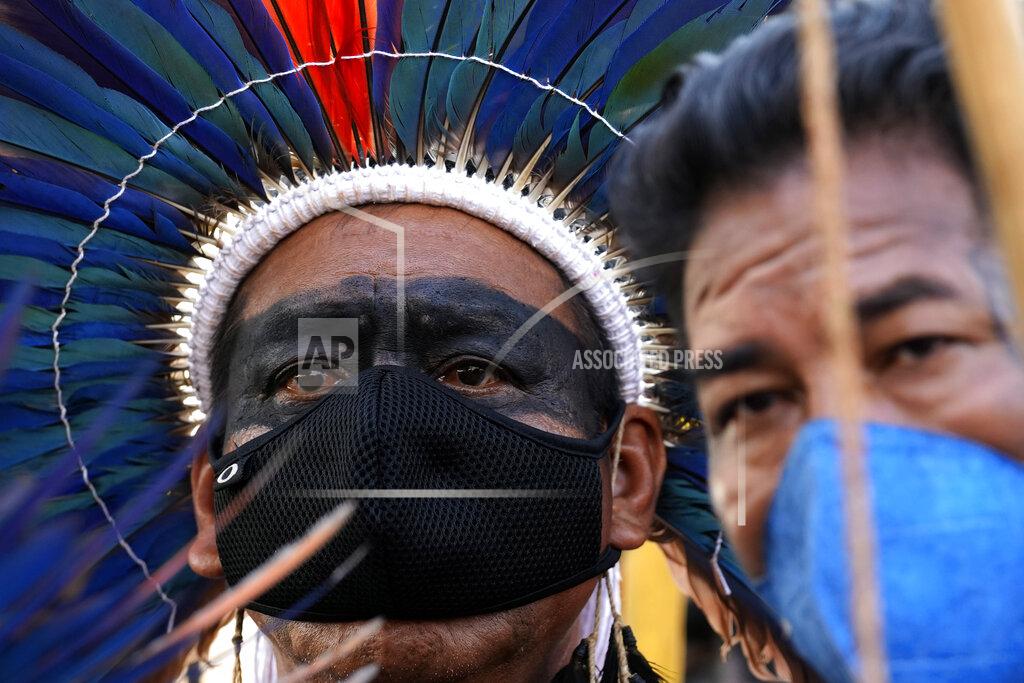 Eraldo Peres Indigenous men react after the Supreme Court judges' decision to suspend the vote that defines the demarcation of Indigenous lands, during a protest in front of the Supreme Court building, in Brasilia, Brazil, Wednesday, Sept. 15, 2021. (AP Photo/Eraldo Peres)
