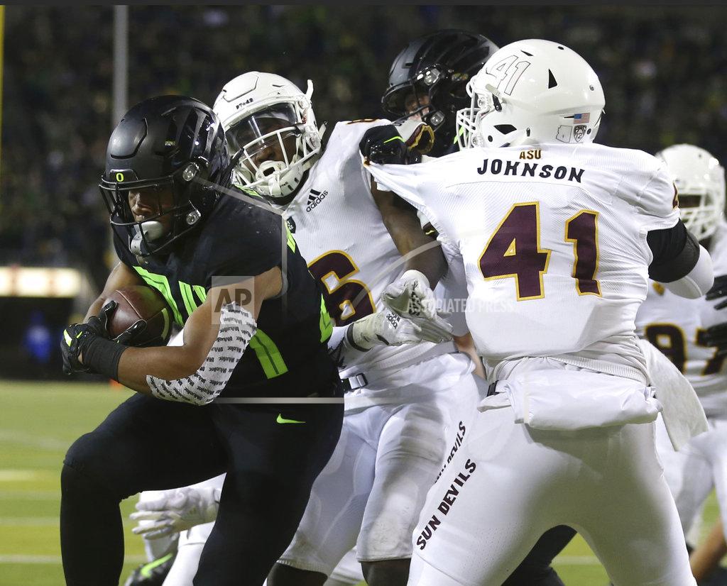 Chris Pietsch Oregon's CJ Verdell, left, breaks tackles by Arizona State's Evan Fields and Tyler Johnson for a touchdown during the first quarter of an NCAA college football game Saturday, Nov. 17, 2018, in Eugene, Ore. (AP Photo/Chris Pietsch)