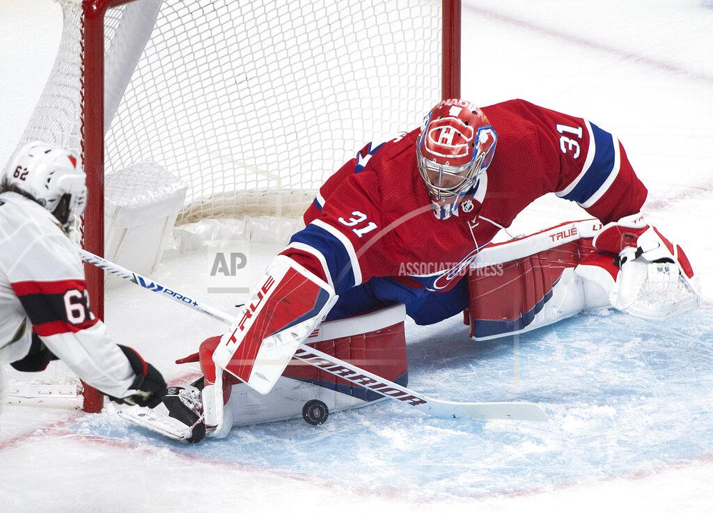 Graham Hughes Montreal Canadiens goaltender Carey Price stops Ottawa Senators' Clark Bishop during the second period of an NHL hockey game in Montreal, Saturday, April 3, 2021. (Graham Hughes/The Canadian Press via AP)