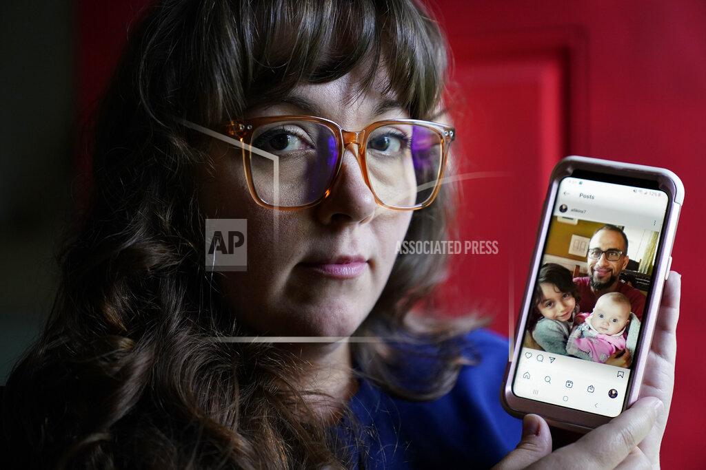 Steven Senne Allison Cullen, of Brockton, Mass., left, displays a family photo on her phone that shows her husband Flavio Andrade Prado, top, their son Gabriel Andrade-Cullen, bottom left, and their daughter Saoirse Andrade-Cullen, bottom right, Thursday, July, 22, 2021, at their home in Brockton. Prado, a Brazilian national, is being held by Immigration and Customs Enforcement, or ICE, at the Plymouth County House of Corrections. Cullen says she and her children haven't been able to visit her husband since before the pandemic. (AP Photo/Steven Senne)