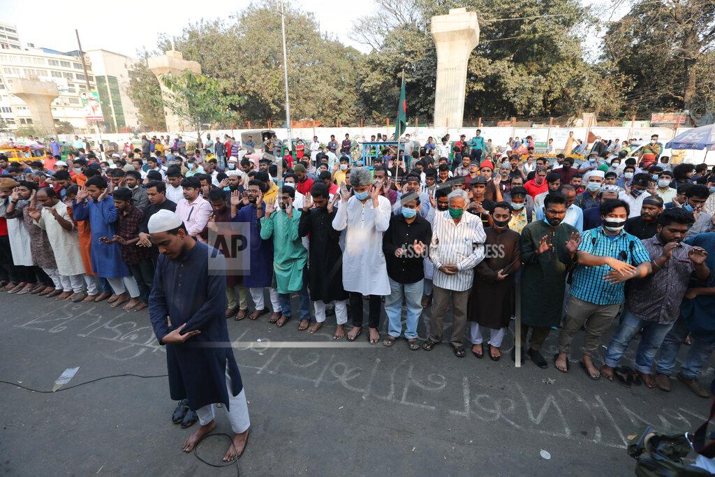 Mahmud Hossain Opu People offer Friday prayers as they gather to protest the death in prison of a writer who was arrested on charges of violating the sweeping digital security, in Dhaka, Bangladesh, Friday, Feb. 26, 2021. Mushtaq Ahmed, 53, was arrested in Dhaka in May last year for making comments on social media that criticized the Prime Minister Sheikh Hasina government's handling of the coronavirus pandemic. He had been denied bail at least six times. (AP Photo/Mahmud Hossain Opu)