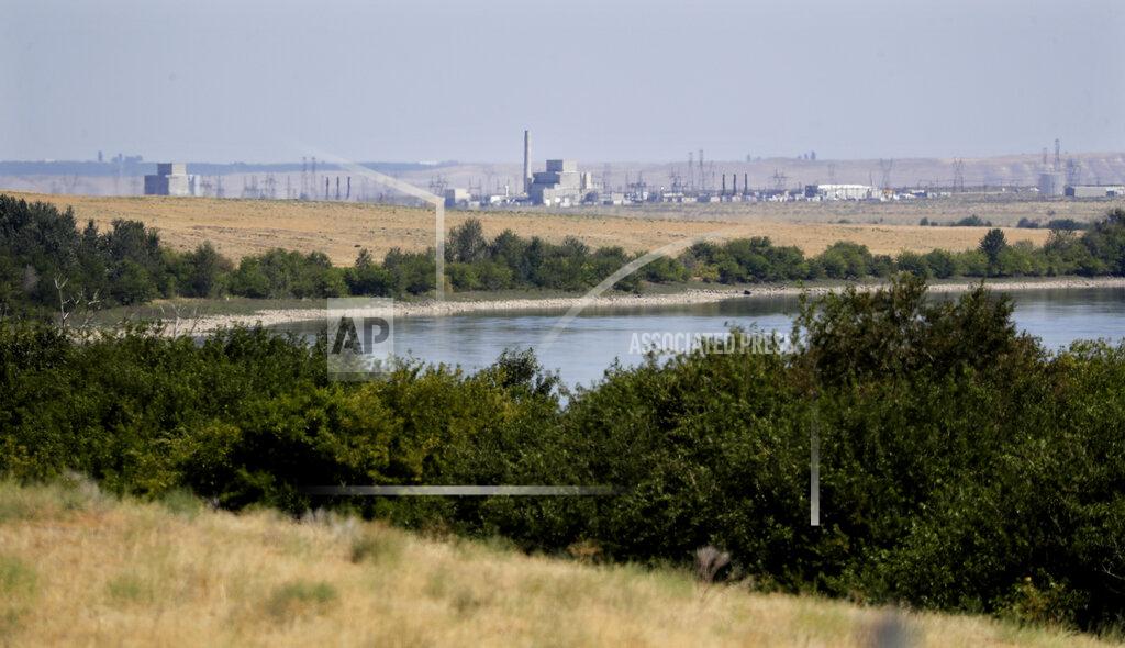Elaine Thompson FILE - In this Aug. 14, 2019 photo, buildings on the Hanford Nuclear Reservation along the Columbia River are seen from the Hanford Reach National Monument near Richland, Wash. The location is featured in a collection of mini-essays by American writers published online by the Frommer's guidebook company about places they believe helped shape and define America. (AP Photo/Elaine Thompson, File)