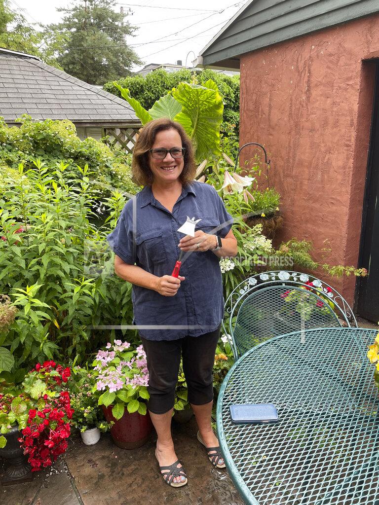 Uncredited Elizabeth Licata, moderator of the Facebook group, WNY Gardeners, poses for a photograph on July 8, 2021 in Buffalo, N.Y. Moderating a Facebook gardening group is not without challenges. Facebook’s algorithms sometimes flag the word “ hoe” as “violating community standards,” apparently referring to a different word, one without an “e” at the end that is nonetheless often misspelled as the garden tool. Licata said it has been futile trying to reach Facebook to correct the mistake. (Elizabeth Licata via AP)