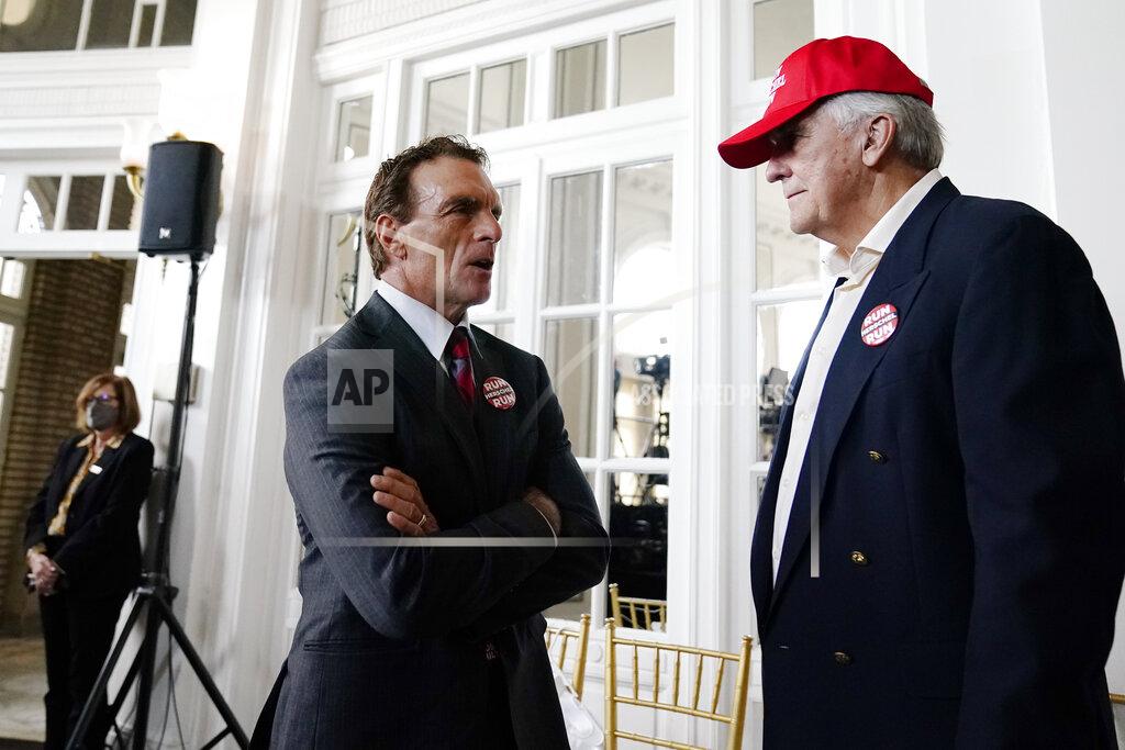 Brynn Anderson Former NFL football player, Doug Flutie, left, speaks with Keith Boyles during an election night watch party for U.S. Senate candidate Herschel Walker, Tuesday, May 24, 2022, in Atlanta. (AP Photo/Brynn Anderson)