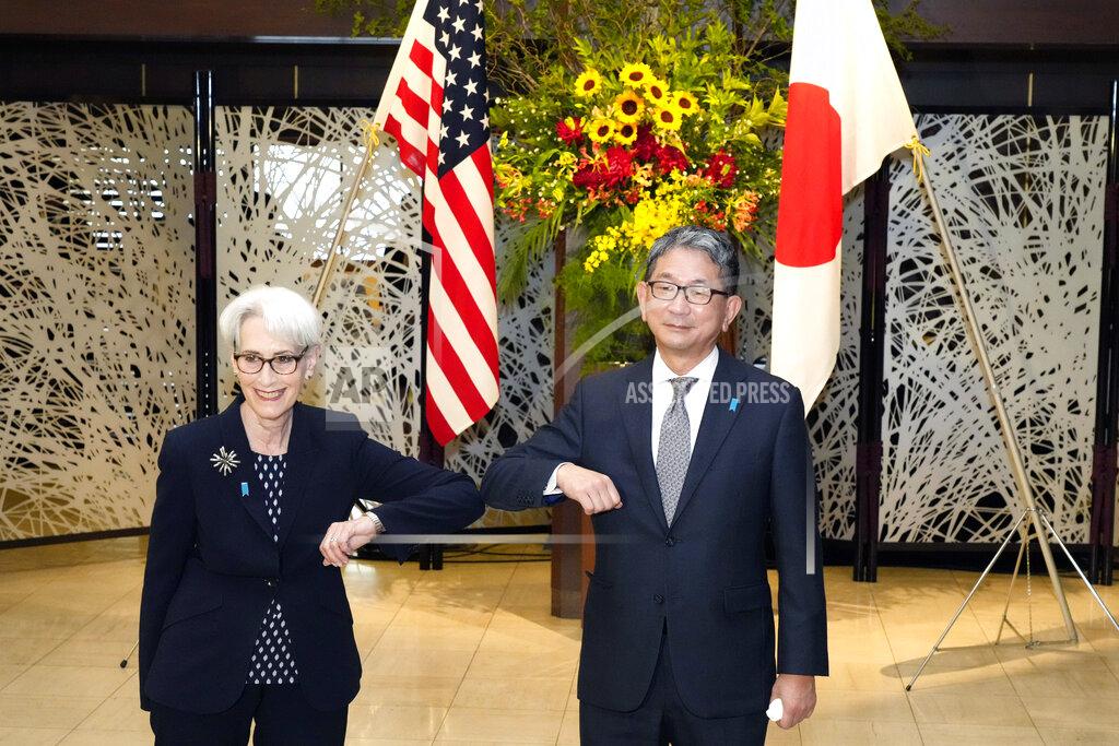 Eugene Hoshiko U.S. Deputy Secretary of State Wendy Sherman, left, elbow bumps with Japanese Vice-Minister for Foreign Affairs Takeo Mori, right, prior to their meeting at the Iikura Guesthouse Tuesday, July 20, 2021, in Tokyo. (AP Photo/Eugene Hoshiko, Pool)
