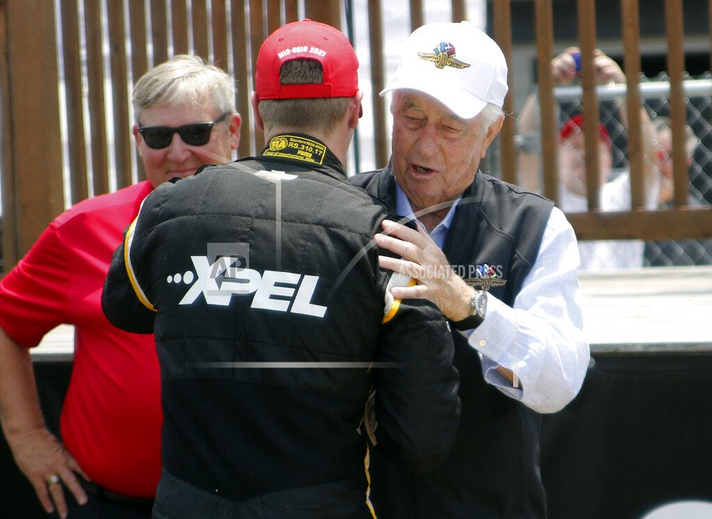 Tom E. Puskar Car owner Roger Penske, right, congratulates Josef Newgarden in victory lane after winning an IndyCar race at Mid-Ohio Sports Car Course in Lexington, Ohio, Sunday, July 4, 2021. (AP Photo/Tom E. Puskar)