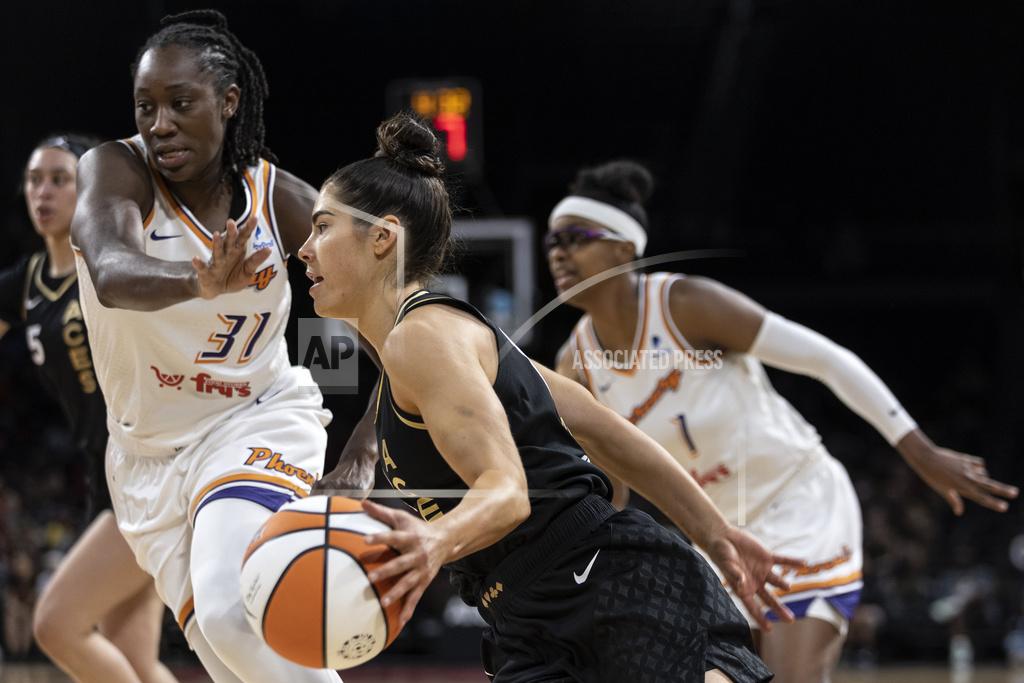 Ellen Schmidt Las Vegas Aces guard Kelsey Plum, center, drives around Phoenix Mercury center Tina Charles (31) during the first half of a WNBA basketball game, Saturday, May 21, 2022, in Las Vegas. Mercury guard Diamond DeShields, right, looks on. (AP Photo/Ellen Schmidt)