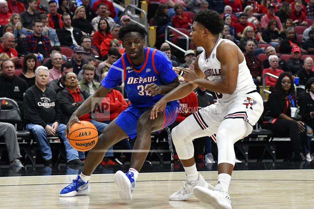 Timothy D. Easley DePaul forward David Jones (32) attempts to get past Louisville guard Noah Locke (0) during the first half of an NCAA college basketball game in Louisville, Ky., Friday, Dec. 10, 2021. (AP Photo/Timothy D. Easley)