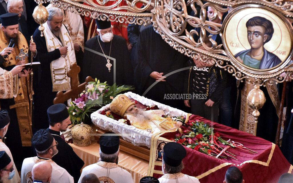 Risto Bozovic Believers pray by the coffin of Bishop Amfilohije, the head of the Serbian Orthodox Church in Montenegro, in Podgorica, Montenegro, Saturday, Oct. 31, 2020. The church said the 82-year-old died Friday from pneumonia caused by COVID-19. Amfilohije, known for his staunch anti-Western and pro-Russian political views, played a key role in leading the anti-government protests and putting together an opposition coalition that is currently trying to form the country's new government. (AP Photo/Risto Bozovic)