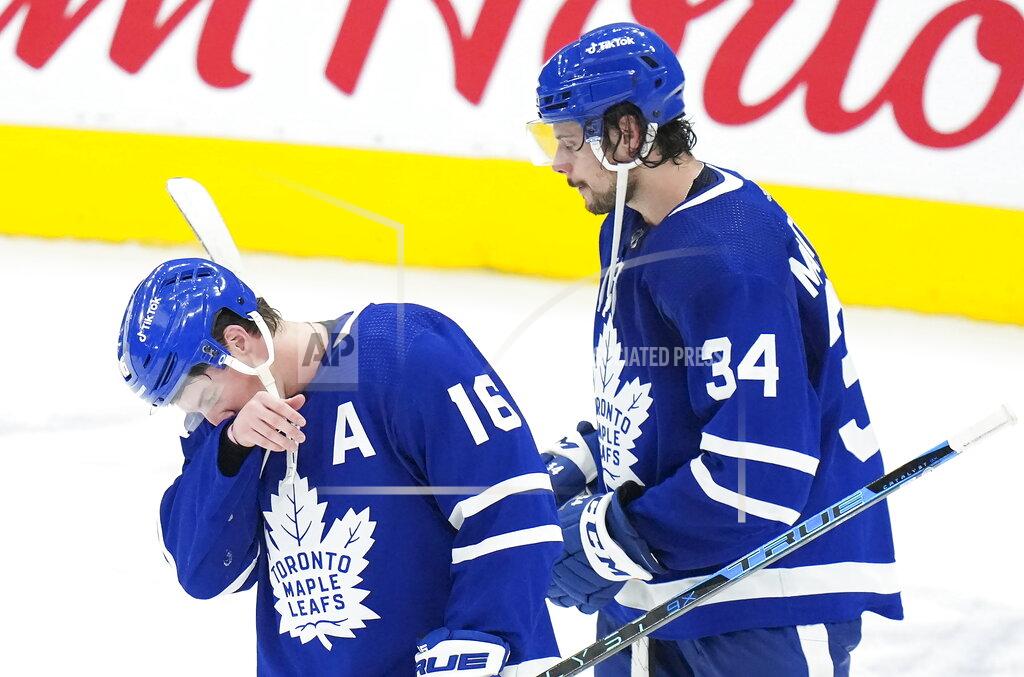 Nathan Denette Toronto Maple Leafs forward Mitchell Marner (16) and teammate Auston Matthews (34) react after being knocked out of the Stanley Cup playoffs in Game 7 of an NHL hockey first-round playoff series against the Tampa Bay Lightning in Toronto, Saturday, May 14, 2022. (Nathan Denette/The Canadian Press via AP)