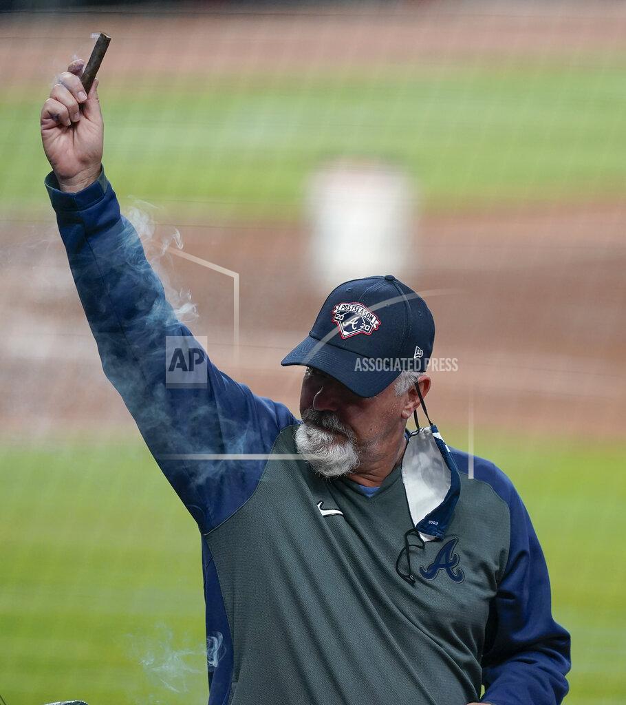 Brynn Anderson The Atlanta Braves pitching coach Rick Kranitz lights a cigar in celebration after a baseball game to clinch the NL East title against the Miami Marlins on Tuesday, Sept. 22, 2020, in Atlanta. (AP Photo/Brynn Anderson)