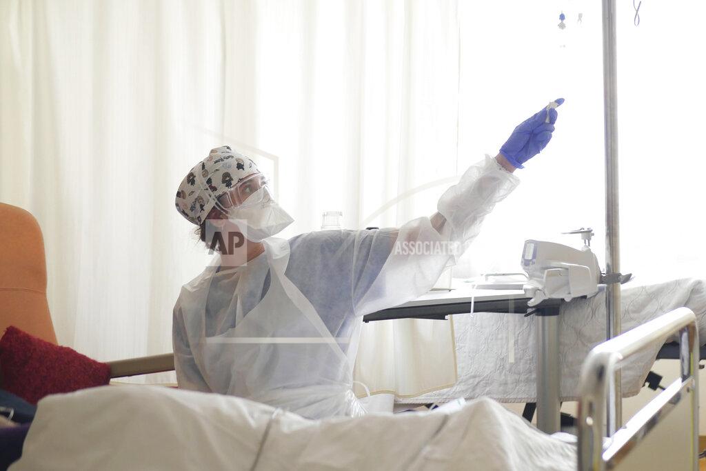 Thibault Camus FILE- In this March 19, 2021, file photo, a nurse tends to a patient affected by COVID-19 virus in the ICU unit at the Ambroise Pare clinic in Neuilly-sur-Seine, near Paris. France's president say he has nothing to be sorry about for refusing to impose a third virus lockdown earlier this year, even though his country is now facing surging infections that are straining hospitals and more than 1,000 people with the virus are dying every week. (AP Photo/Thibault Camus, File)